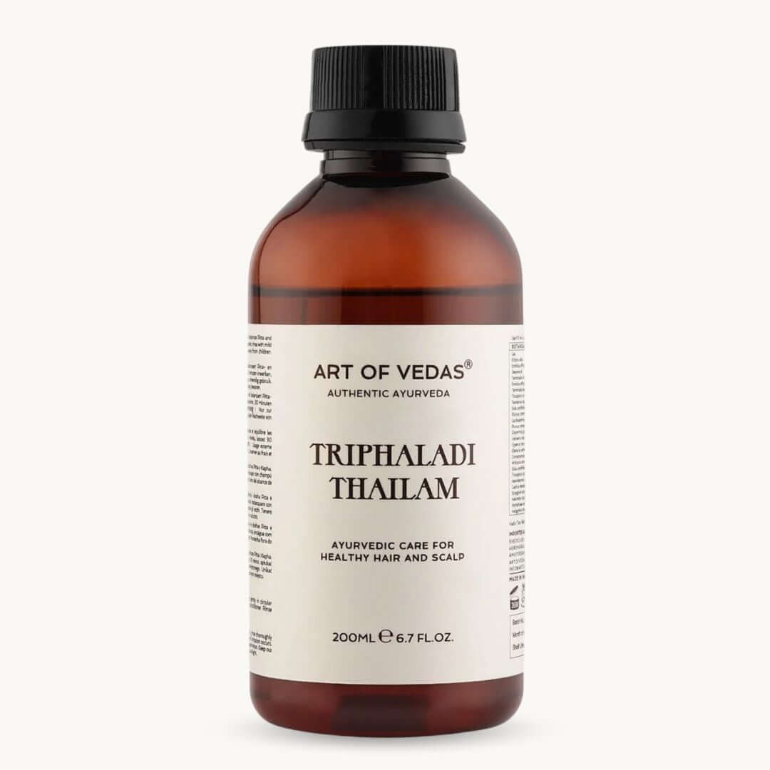 Bottle of Art of Vedas Triphaladi Thailam on a white background