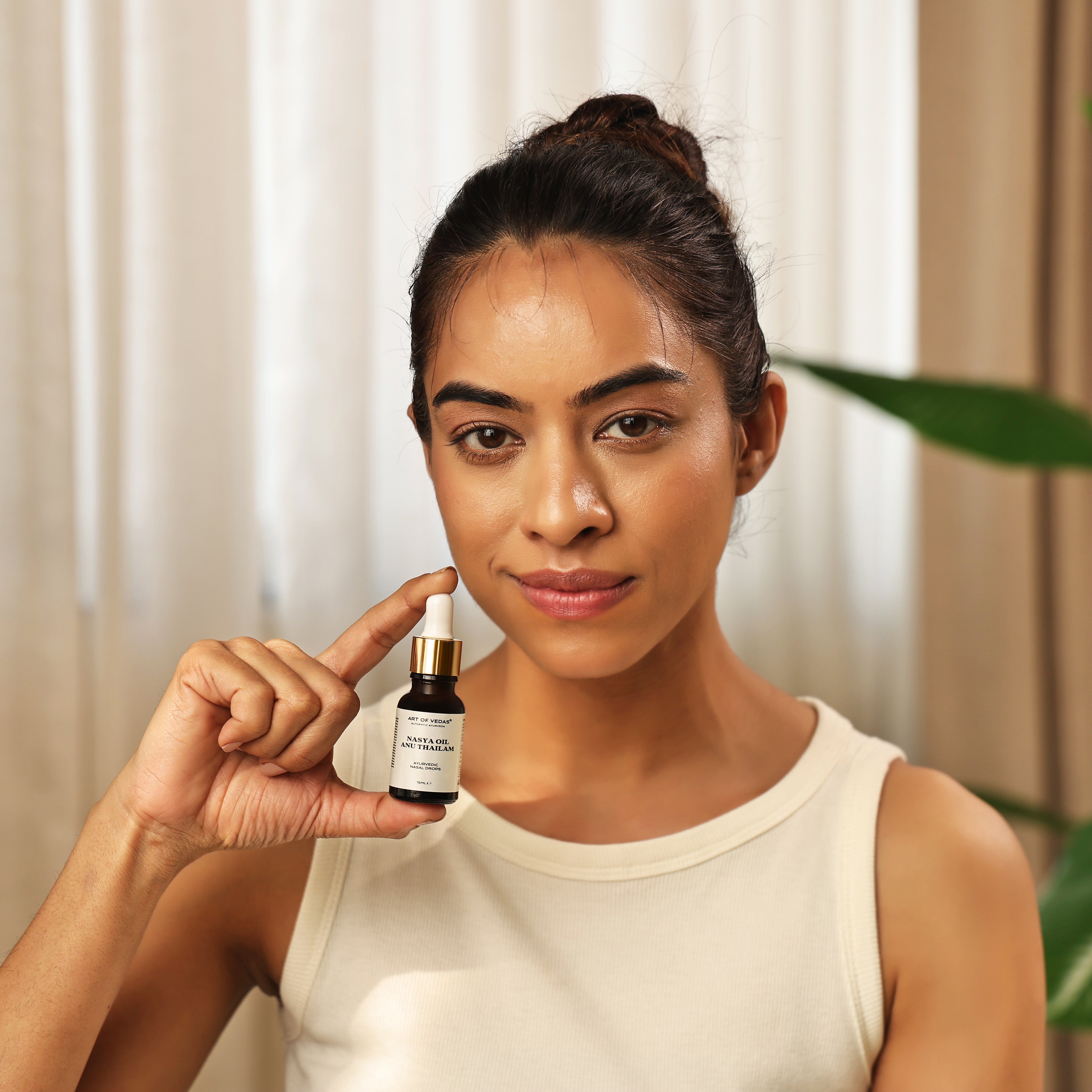 Art of Vedas Nasya Oil Anu Thailam - Woman Holding Ayurvedic Anu Thailam Nasal Oil for Sinus Balance and Respiratory Health